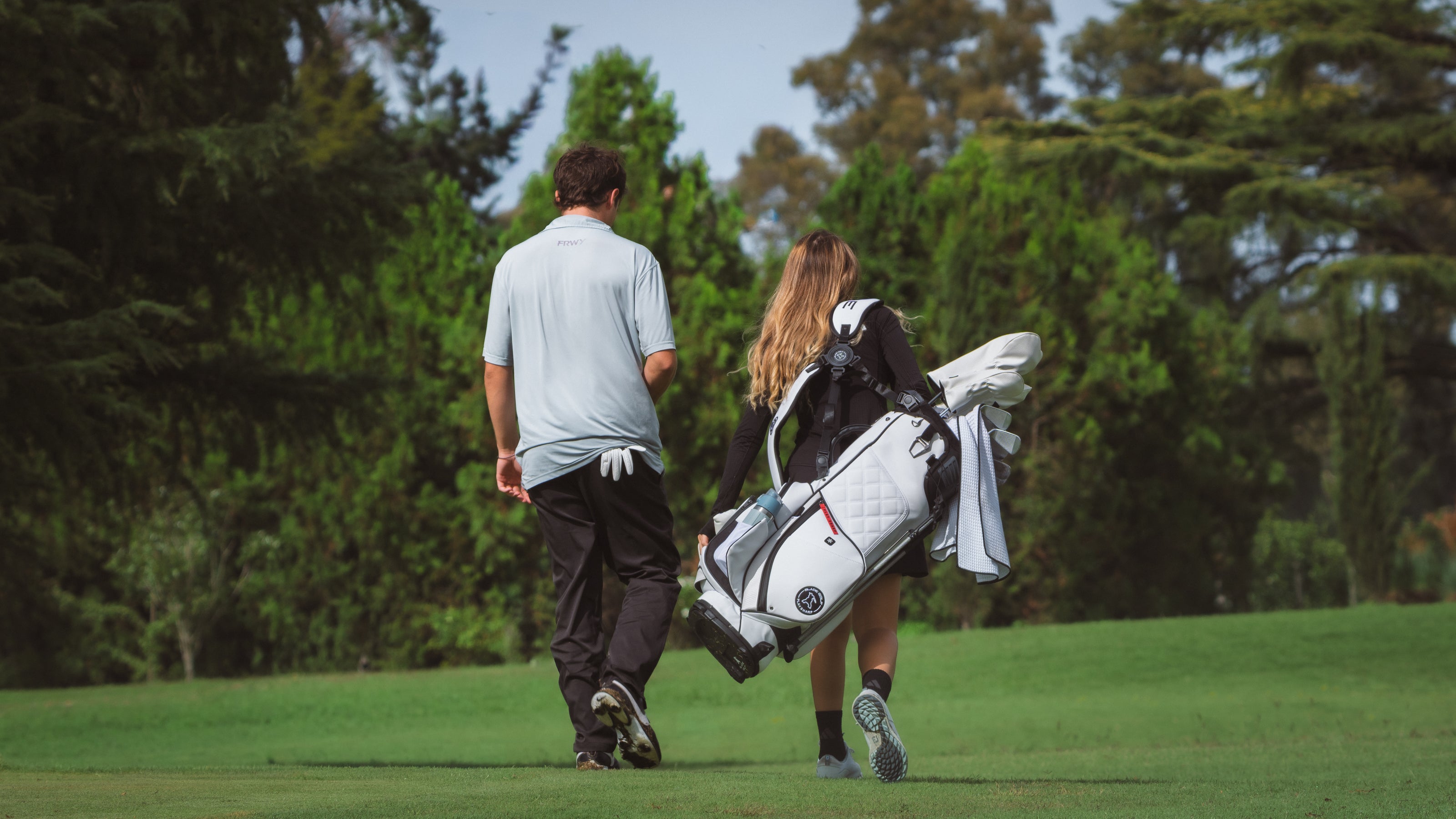 Player and Caddy whalking on the fairway